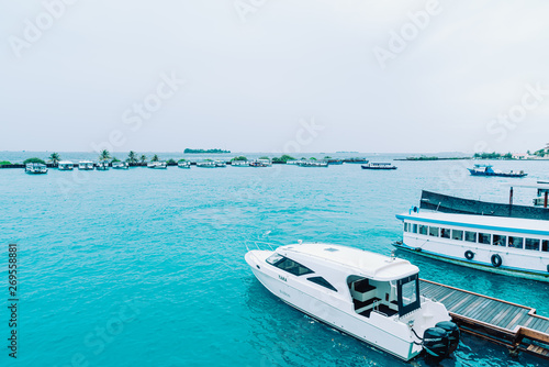 Fototapeta Naklejka Na Ścianę i Meble -  HULHULE, MALDIVES - MAY 23, 2019: Boats and ferries at the harbor outside Velana airport in Hulhule.