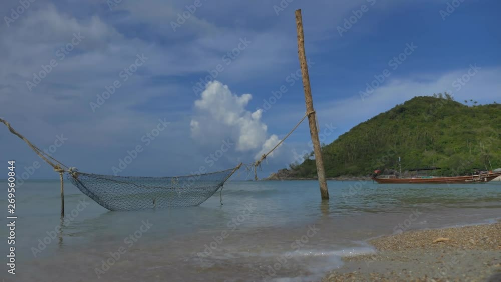 Empty tropical sand beach, long tail taxi boats slowly moving on water, never endless stati shot with no color grading Empty tropical sand beach, long tail taxi boats slowly moving on water, never endless stati shot with no color grading