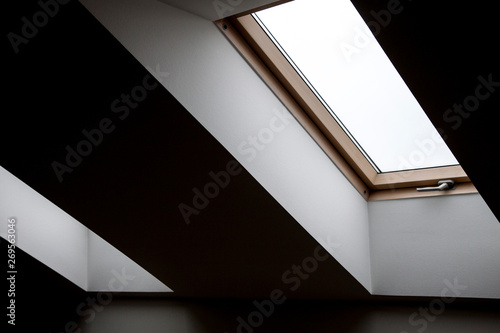 Windows in the attic. Architectural elements. Contrasting geometric interior details, white walls, ceilings, frames, empty room.