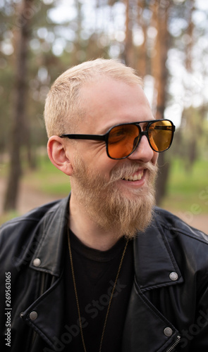 Portrait hipster young guy with a beard and mustache with sunglasses © leberus