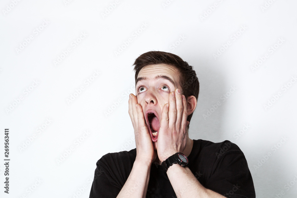 Portrait of a young handsome man in black t-shirt over white background. Portrait of a young handsome man in black t-shirt over white background.