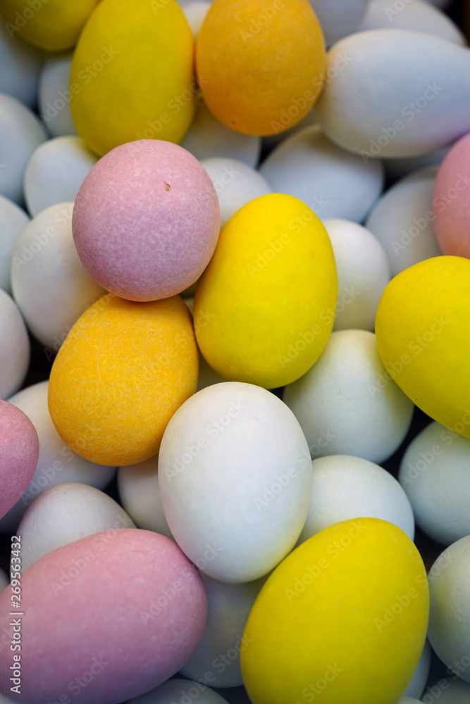 Small colorful chocolate eggs in hard sugar shell in bulk for Easter Small colorful chocolate eggs in hard sugar shell in bulk for Easter
