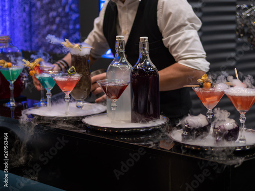the bartender mixes a cocktail