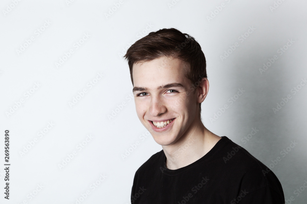 Portrait of a young handsome man in black t-shirt over white background. Portrait of a young handsome man in black t-shirt over white background.