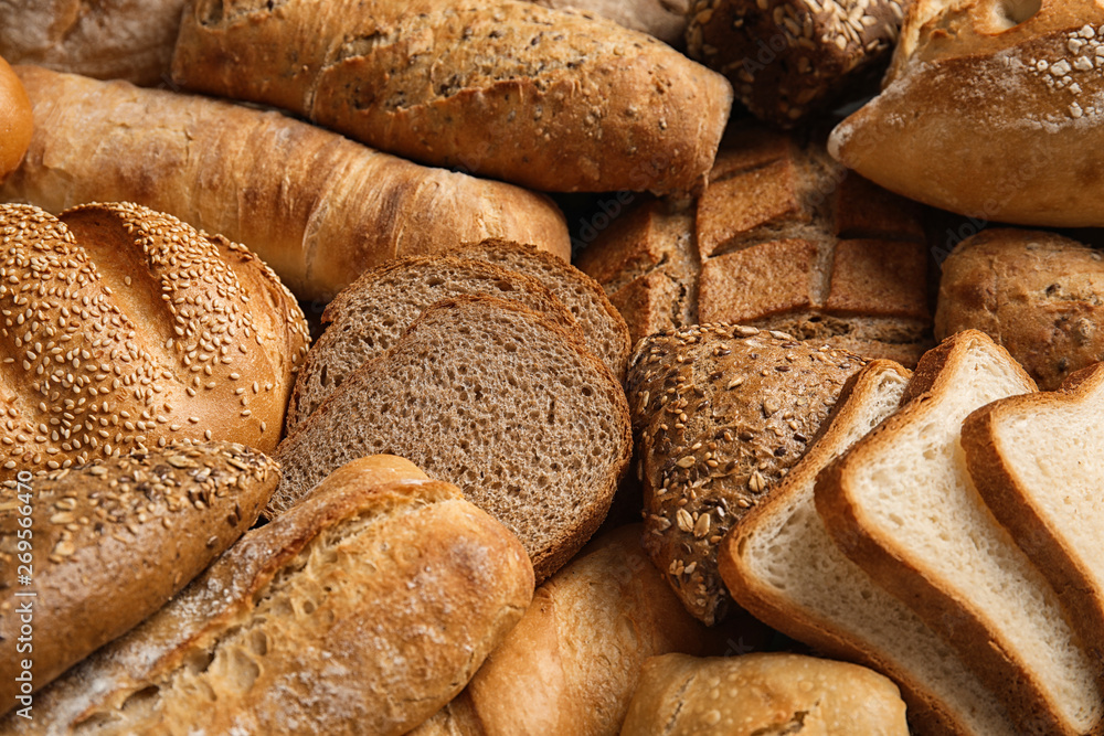 Different kinds of fresh bread as background, closeup