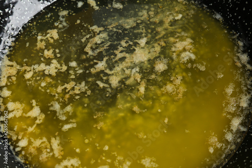Tasty melting butter in frying pan, closeup © New Africa
