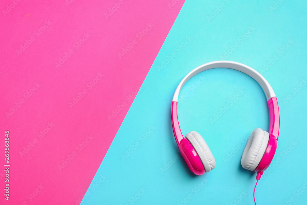 Stylish headphones on color background, top view. Space for text Stylish headphones on color background, top view. Space for text