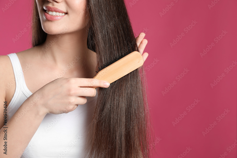 Woman with hair brush on color background, closeup. Space for text Woman with hair brush on color background, closeup. Space for text