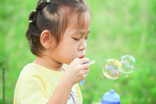 Asian girls are playing blowing bubbles into balloons in parks in Thailand.