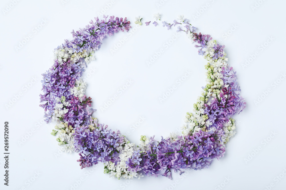 Blossoming lilac flowers on white background, top view. Space for text Blossoming lilac flowers on white background, top view. Space for text