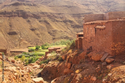Berber village in valley surrounded by rugged high mountain walls with old brick clay houses © Ralf