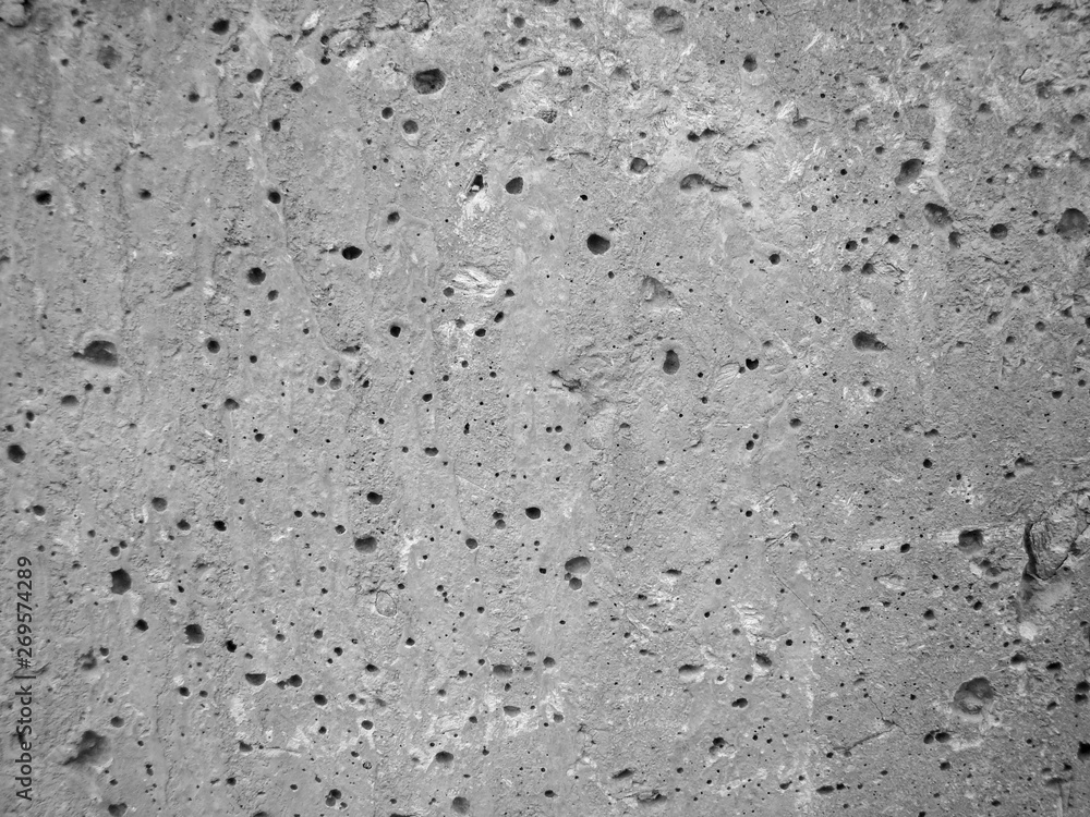 Background gray concrete wall. Caverns. Texture with smudges, fissures. Background gray concrete wall. Caverns. Texture with smudges, fissures.