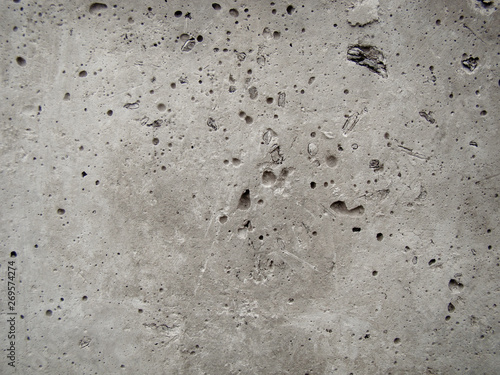 Background concrete wall. Caverns. Inclusions from wood. Texture with smudges, trushins.