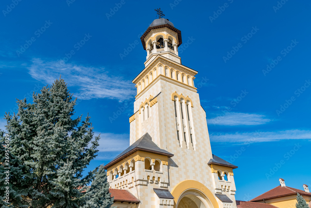 Beautiful view to the Coronation Reunification Cathedral Bell Tower in Alba Iulia city, Romania. A Bell Tower on a sunny day in Alba Iulia, Romania