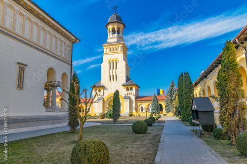 Beautiful view to the Coronation Reunification Cathedral Bell Tower in Alba Iulia city, Romania. A Bell Tower on a sunny day in Alba Iulia, Romania photo