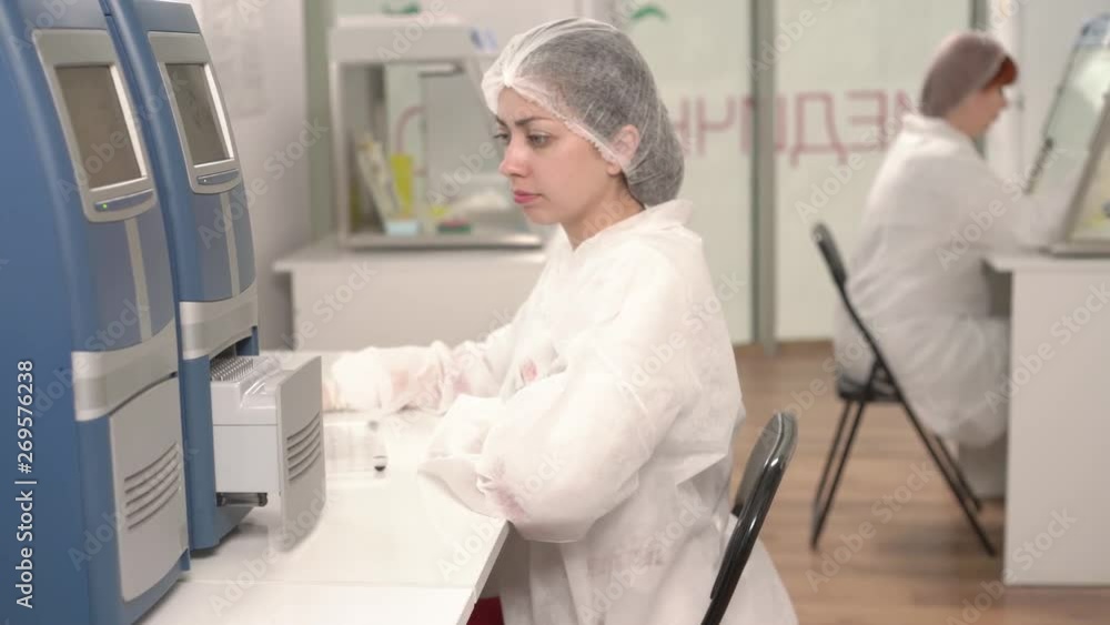 Medical technologists working in a modern lab. Scientists using modern laboratory equipment. Close-up demonstration video Medical technologists working in a modern lab. Scientists using modern laboratory equipment. Close-up demonstration video