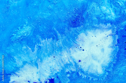 Abstract art texture background. Sea wave foam design. Beautiful blue and white paints with bubbles and sparkling effect.