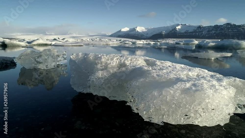 Wallpaper Mural Flying above floating Icebergs. Ice from Glacier crystal shining. Ice Lagoon Global warming Explore Iceland. Torontodigital.ca