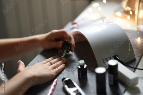 Making a manicure, hybrid polish, uv lamp, beautician work