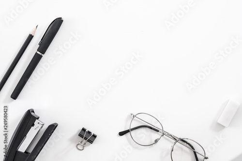 Business routine essentials. Office supplies set. Flat lay of stationery and eyeglasses over white background. Copy space.