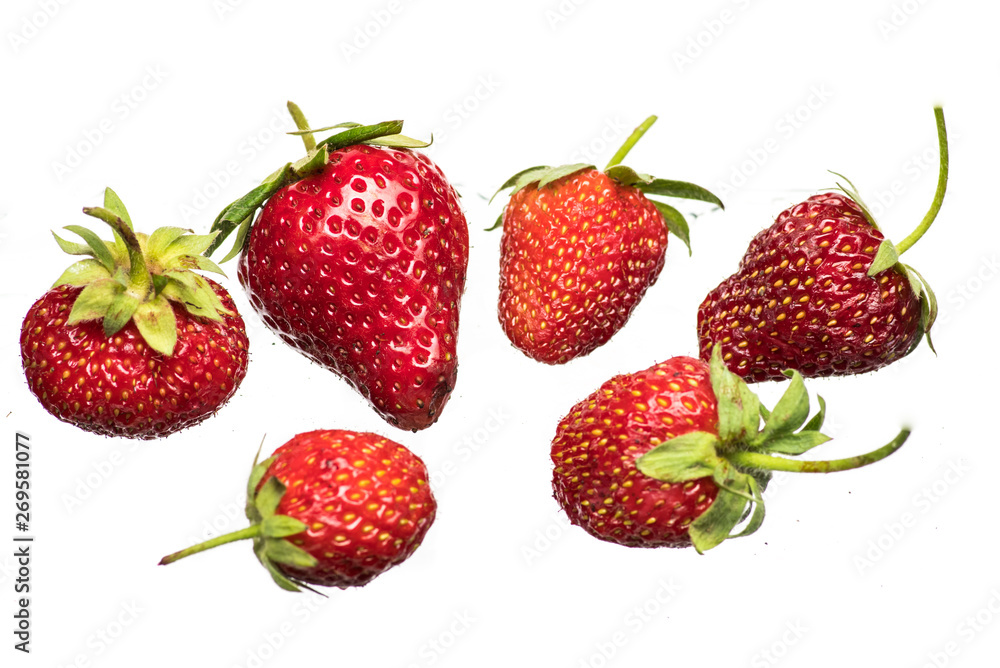 Ripe strawberries on a light background with splashing water close up Ripe strawberries on a light background with splashing water close up