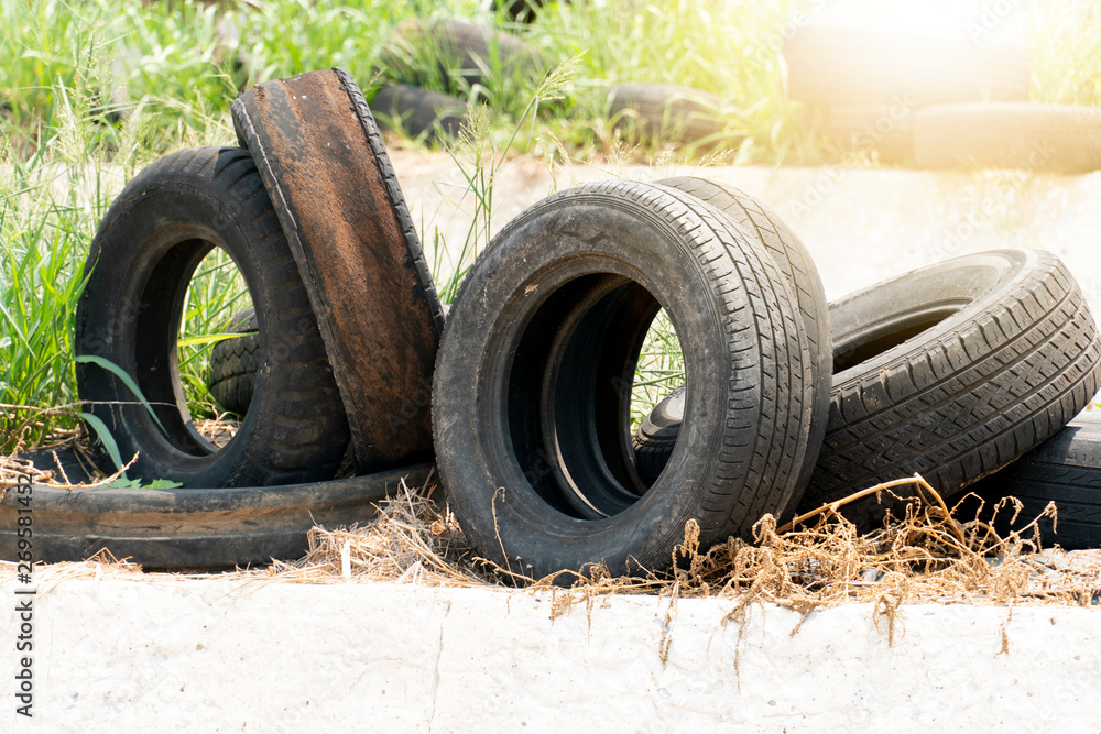 Pile of used tires and leave them on the grass. Pile of used tires and leave them on the grass.