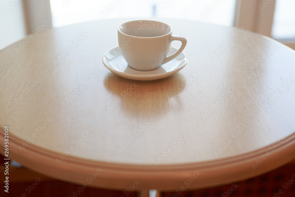 Fototapeta premium wooden table white Cup and saucer side view