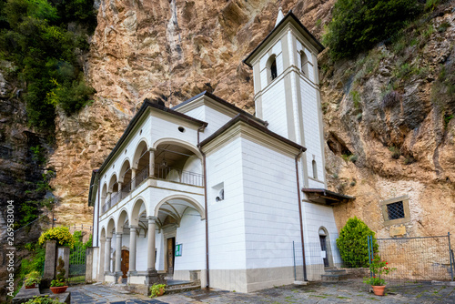 View of the beautiful Hermitage of Calomini (Eremo di Calomini), placed in a spectacular position, at the base of a sheer limestone wall. Vergemoli, Lucca, Garfagnana, Tuscany, Italy photo