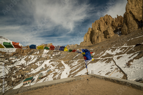 tibetan flags in foreground in a village in spiti valley