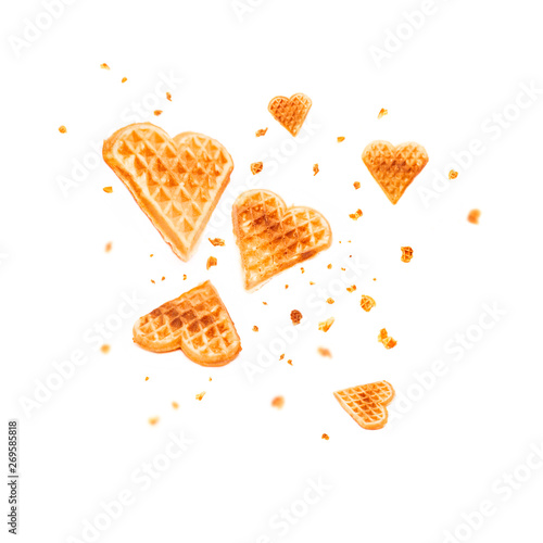 Cookies waffles in shape of heart on white background. Levitation in air. Card for holidays Valentine's Day, Women's Day, Mother's Day. Homemade sweets. love food concept