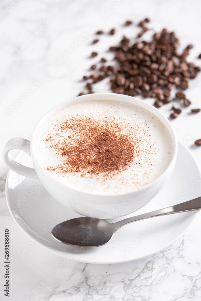cappuccino with coffee beans on marble background cappuccino with coffee beans on marble background