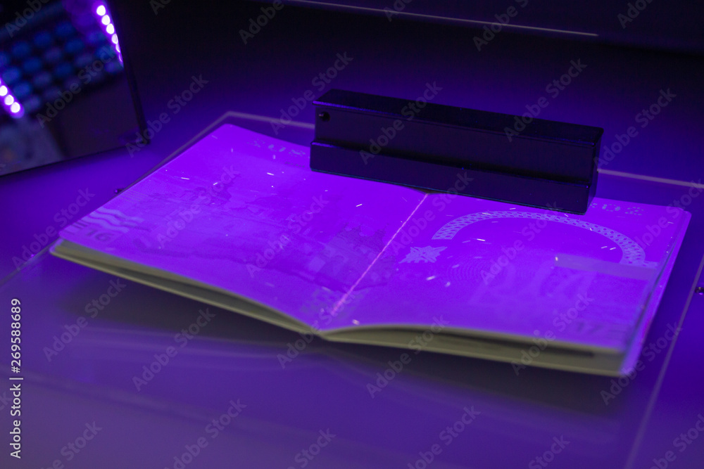 Checking the passport for fraud in UV light, detection of luminescence of protective components of the document (threads, melange fibers), special elements of micro-printing and high security print 