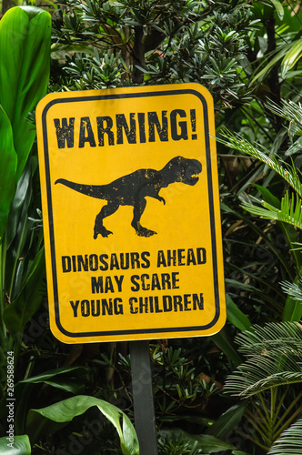 funny notice board show dinosaur in green forest