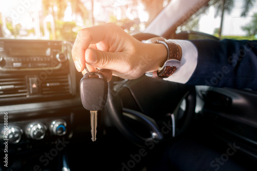 Business man  is holding key car in the car © tonefotografia
