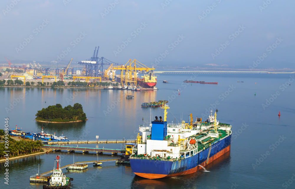 commercial Oil ship tanker park to port for transfer crude oil to oil refinery.