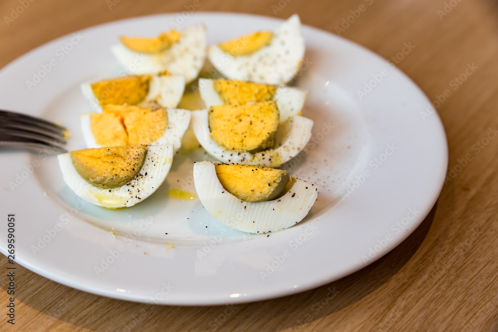 Boiled eggs with salt pepper and olive oil