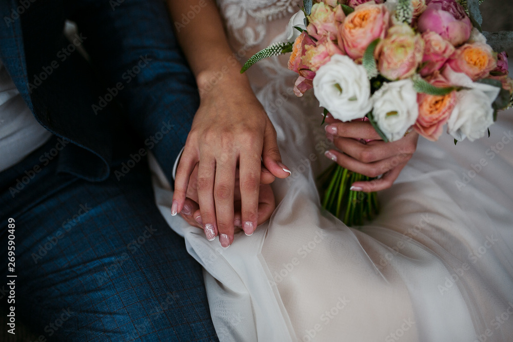 Bridal bouquet in the hands of the newlyweds Bridal bouquet in the hands of the newlyweds