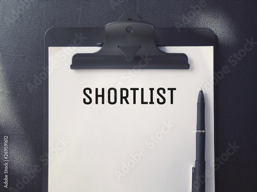 Business or Job Hiring concept - Top view of a clipboard and white sheet with SHORTLIST written on it. photo
