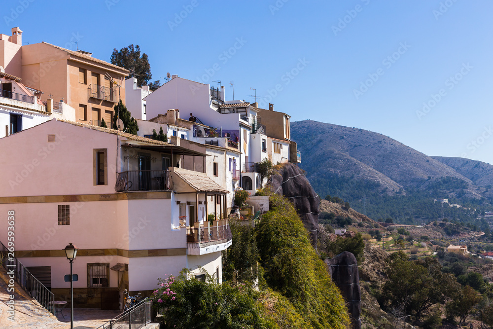 Obraz premium The facades of the white houses of the Spanish old town of Finestrat are built in the mountains.