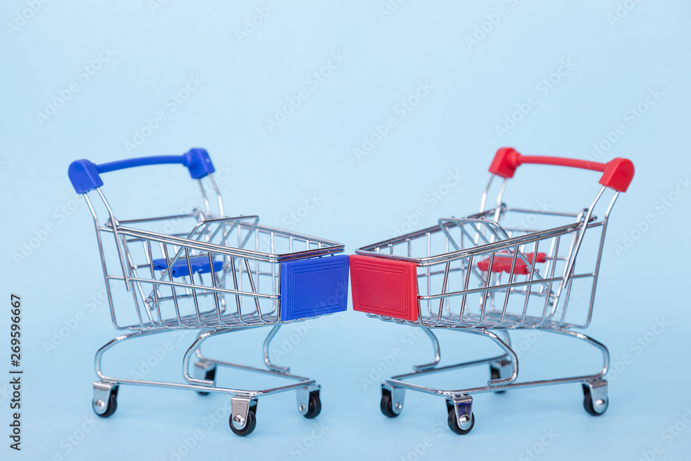 Empty grocery carts on wheels on a blue background