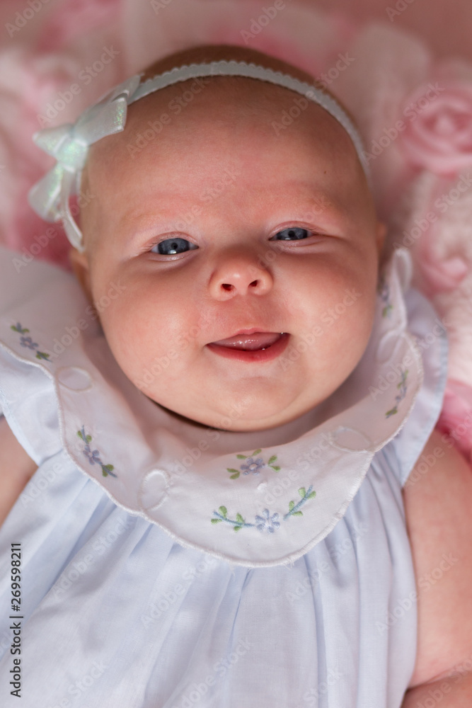 Smiling 2 month old baby girl in pretty white dress smiling from above Stock Photo Adobe Stock