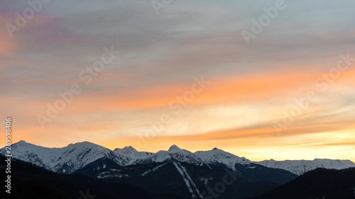 Sunset over the Caucasus mountains covered by snow in the ski resort of Sochi, Russia.