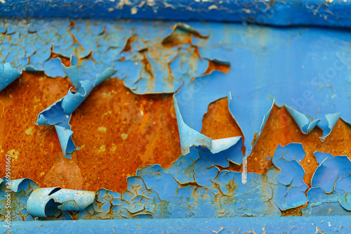blue paint on rusty metal peels off and peels off