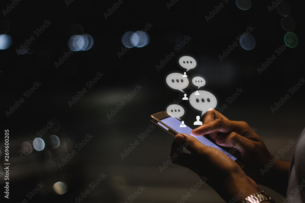 Φωτογραφία Businesswoman using smartphone at night in the city ,social, media, marketing concept