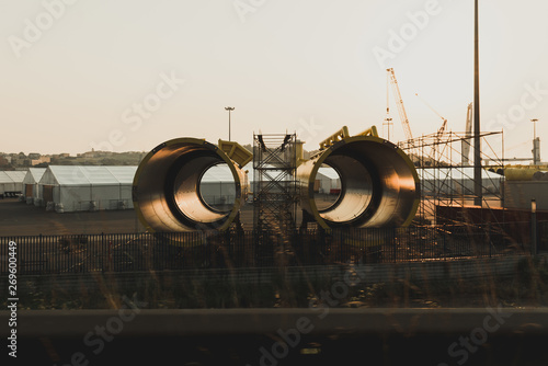 New big metal yellow pipe segments for oil locating on industrial ground