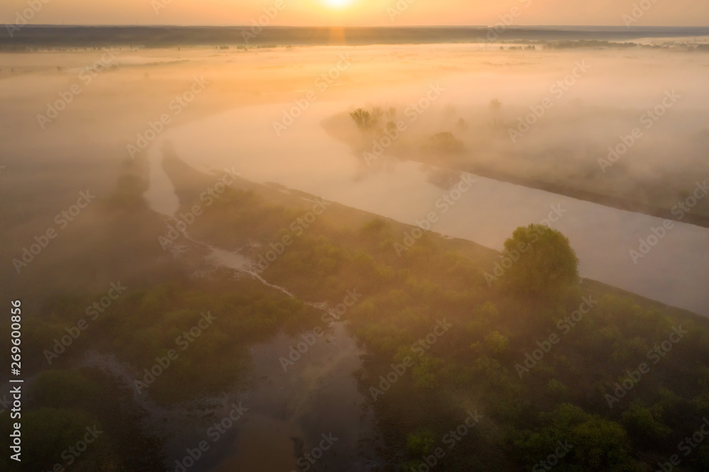 Sunrise over river. Sunny summer nature in sunlight. Amazing morning on riverside from above. Aerial nature landscape Sunrise over river. Sunny summer nature in sunlight. Amazing morning on riverside from above. Aerial nature landscape