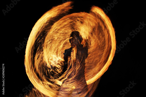 silhouette of a man against a background of sparks and fire during a fiery show