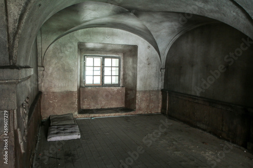 The interior of an abandoned old house with a mattress for sleeping lying on the floor. Used by homeless people to stay overnight.  © shootingtheworld