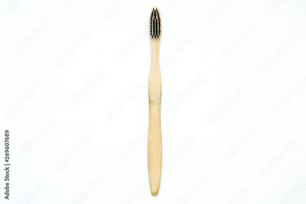 A toothbrush from natural materials. Made from bamboo wood. Isolated on a white background. A toothbrush from natural materials. Made from bamboo wood. Isolated on a white background.