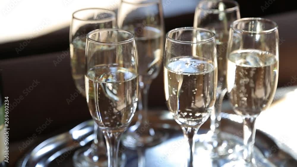 Group of glasses with sparking champagne shining at sun rays. Close up Group of glasses with sparking champagne shining at sun rays. Close up